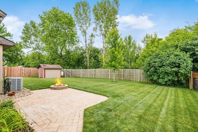 4051 Tamarack Ave, Grove City, OH 43123 - fenced backyard with an outdoor fire pit, a patio area, and a storage unit