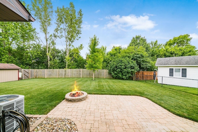 4051 Tamarack Ave, Grove City, OH 43123 - fenced backyard with a patio, a fire pit, and view of wooded area