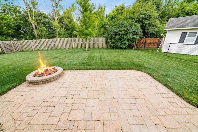 4051 Tamarack Ave, Grove City, OH 43123 - fenced backyard with a patio, an outdoor fire pit, and view of wooded area