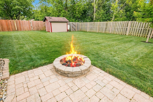 4051 Tamarack Ave, Grove City, OH 43123 - fenced backyard featuring a patio, a fire pit, and a storage unit