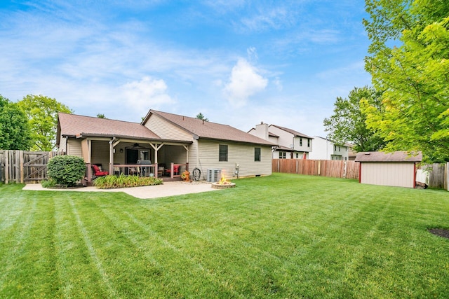 4051 Tamarack Ave, Grove City, OH 43123 - rear view of property with a patio area, a fenced backyard, a ceiling fan, and a storage shed