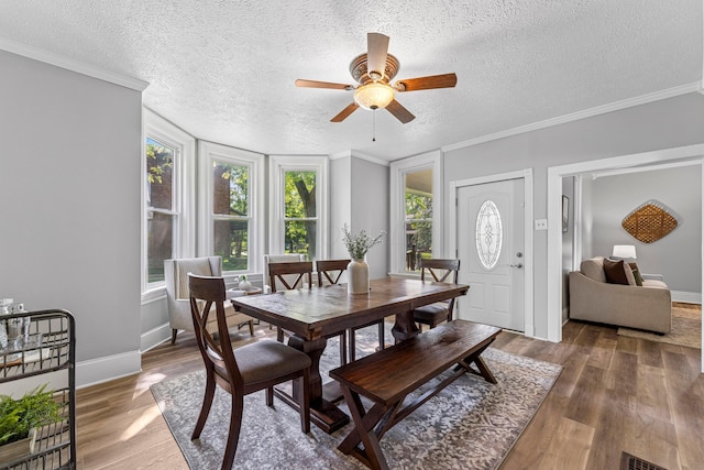 264 W High St, Mount Gilead, OH 43338 - dining area featuring plenty of natural light, a textured ceiling, ceiling fan, wood finished floors, and crown molding