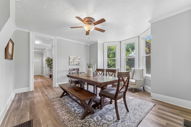 264 W High St, Mount Gilead, OH 43338 - dining area featuring ceiling fan, wood finished floors, a textured ceiling, and crown molding