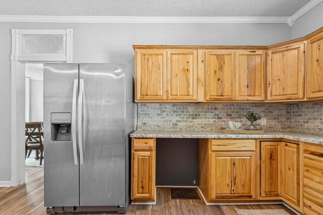 264 W High St, Mount Gilead, OH 43338 - kitchen with stainless steel fridge with ice dispenser, light wood finished floors, crown molding, tasteful backsplash, and a textured ceiling