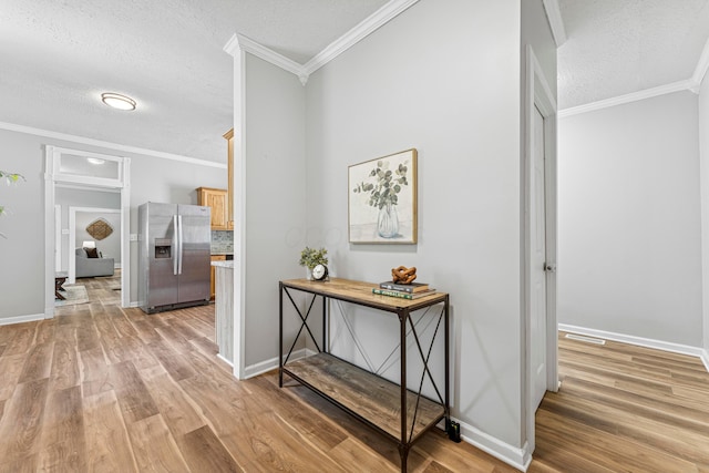 264 W High St, Mount Gilead, OH 43338 - hallway featuring light wood-style flooring, a textured ceiling, and crown molding