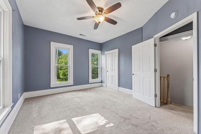 264 W High St, Mount Gilead, OH 43338 - unfurnished bedroom with a textured ceiling, carpet flooring, ceiling fan, and a closet