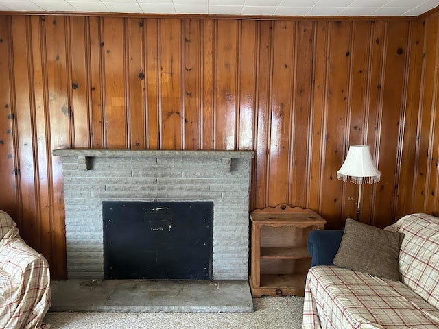 12317 State Route 188, Thornville, OH 43076 - living room with a fireplace with raised hearth, wood walls, and light carpet