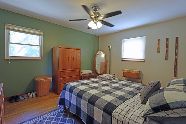 4792 Mcfadden Rd, Columbus, OH 43229 - bedroom with wood finished floors, multiple windows, and a ceiling fan