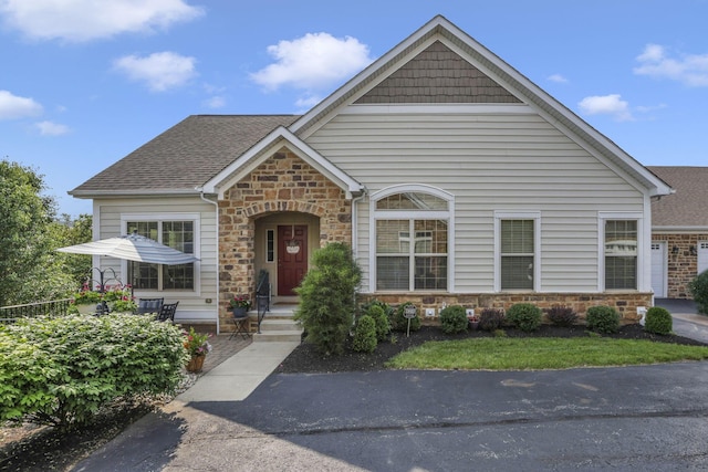 5685 Slater Rdg, Hilliard, OH 43026 - view of front facade featuring stone siding and roof with shingles