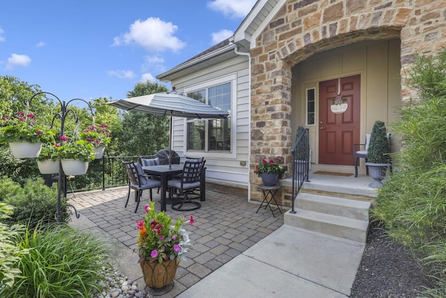 5685 Slater Rdg, Hilliard, OH 43026 - property entrance with stone siding, a patio, and outdoor dining area