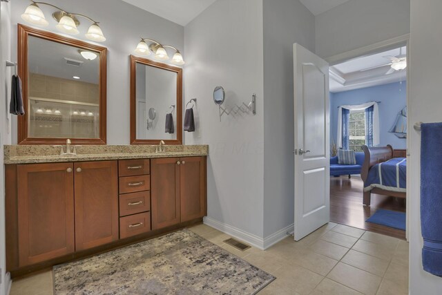 5685 Slater Rdg, Hilliard, OH 43026 - ensuite bathroom featuring double vanity, a tile shower, ceiling fan, and tile patterned floors