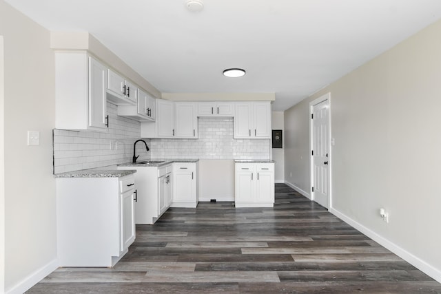 2045 Joyce Ave, Columbus, OH 43219 - kitchen featuring decorative backsplash, white cabinets, and dark wood finished floors
