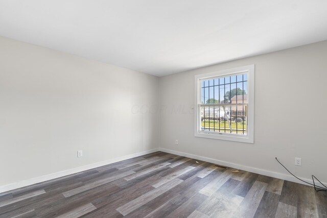 2045 Joyce Ave, Columbus, OH 43219 - unfurnished room with dark wood-style flooring and baseboards