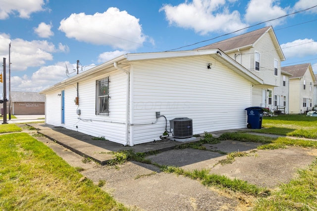 2045 Joyce Ave, Columbus, OH 43219 - view of side of home featuring a central air condition unit and a lawn