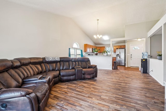 921 Harbinger Cir E, Columbus, OH 43213 - living room featuring wood finished floors, a chandelier, and high vaulted ceiling