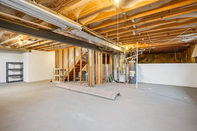 921 Harbinger Cir E, Columbus, OH 43213 - unfinished basement featuring gas water heater, stairway, and heating unit