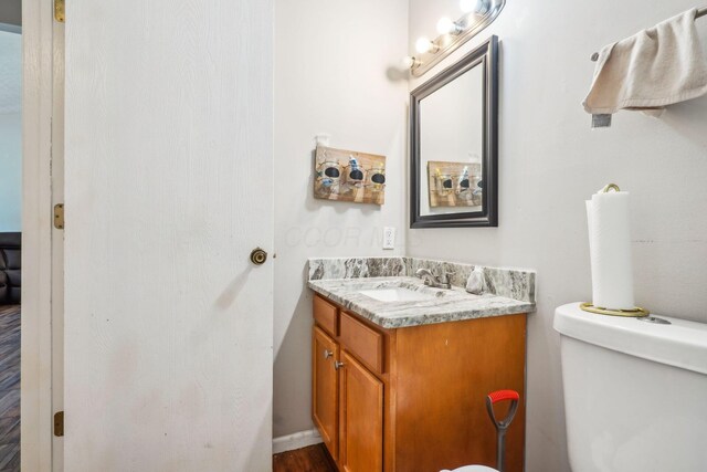 921 Harbinger Cir E, Columbus, OH 43213 - half bath featuring vanity and wood finished floors
