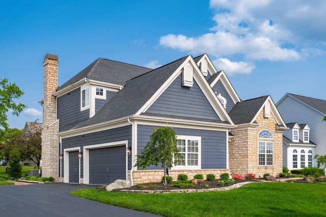 7212 New Albany Links Dr, New Albany, OH 43054 - traditional-style home with stone siding, a chimney, asphalt driveway, and a front yard