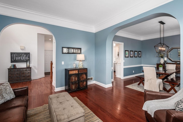 7212 New Albany Links Dr, New Albany, OH 43054 - living area featuring arched walkways, wood finished floors, ornamental molding, and a chandelier