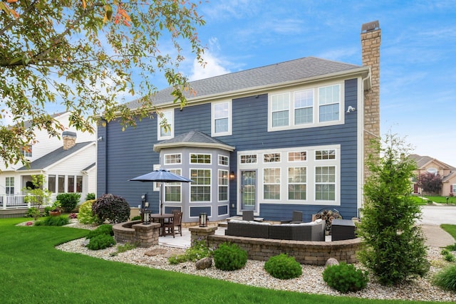 7212 New Albany Links Dr, New Albany, OH 43054 - back of house with a chimney, outdoor lounge area, a patio, and a yard