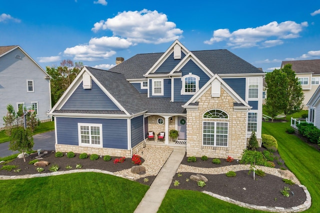 7212 New Albany Links Dr, New Albany, OH 43054 - view of front of property with stone siding, a shingled roof, a front lawn, and a porch