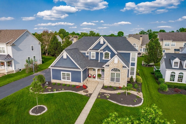 7212 New Albany Links Dr, New Albany, OH 43054 - traditional-style home with stone siding, roof with shingles, a front lawn, and a residential view