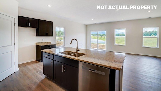 183 Badger Pass, Newark, OH 43055 - kitchen featuring dishwasher, light wood-style flooring, light stone countertops, a kitchen island with sink, and recessed lighting