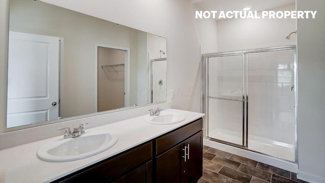 183 Badger Pass, Newark, OH 43055 - bathroom with a stall shower, double vanity, and a walk in closet