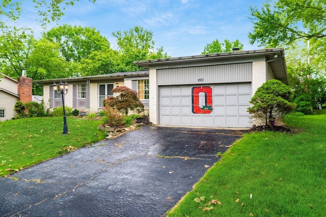 893 Singing Hills Ln, Columbus, OH 43235 - view of front of home with brick siding, driveway, a front lawn, and a garage