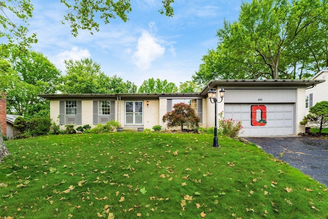 893 Singing Hills Ln, Columbus, OH 43235 - view of front of house with driveway, a garage, a front yard, and brick siding
