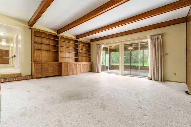 893 Singing Hills Ln, Columbus, OH 43235 - unfurnished living room featuring beamed ceiling, carpet, and built in shelves