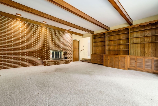 893 Singing Hills Ln, Columbus, OH 43235 - unfurnished living room featuring beamed ceiling, carpet flooring, a fireplace, and brick wall
