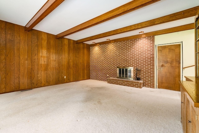 893 Singing Hills Ln, Columbus, OH 43235 - unfurnished living room with a fireplace, beamed ceiling, carpet floors, and wood walls