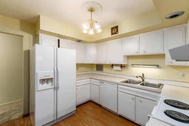 893 Singing Hills Ln, Columbus, OH 43235 - kitchen with white appliances, light wood-style flooring, white cabinets, light countertops, and wall chimney range hood