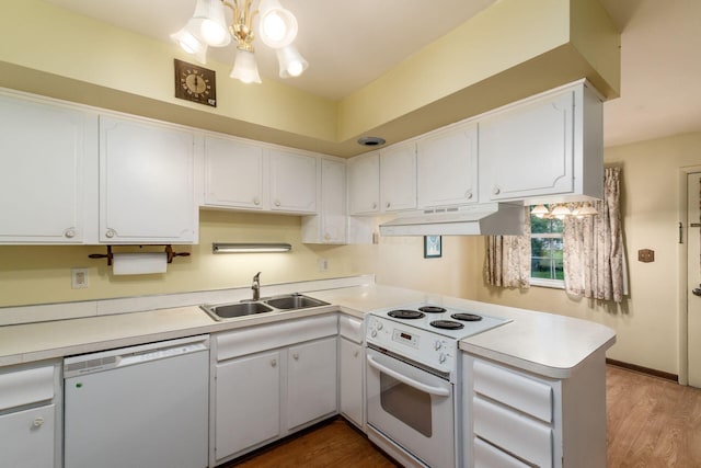 893 Singing Hills Ln, Columbus, OH 43235 - kitchen with white appliances, under cabinet range hood, a peninsula, and light countertops