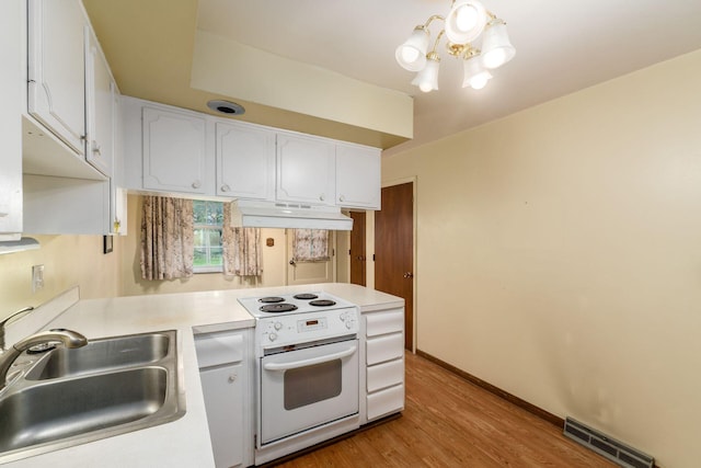 893 Singing Hills Ln, Columbus, OH 43235 - kitchen with white electric range oven, under cabinet range hood, white cabinetry, a chandelier, and light countertops