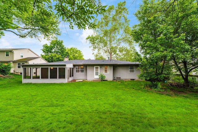 893 Singing Hills Ln, Columbus, OH 43235 - rear view of house featuring a sunroom, a yard, a chimney, entry steps, and crawl space