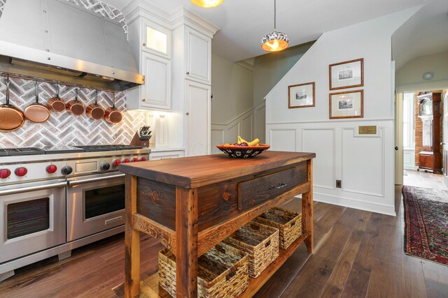33 E Frankfort St, Columbus, OH 43206 - kitchen with double oven range, exhaust hood, a decorative wall, white cabinets, and glass insert cabinets