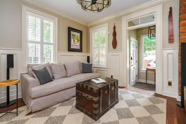 33 E Frankfort St, Columbus, OH 43206 - living area with a decorative wall, a chandelier, crown molding, a wainscoted wall, and light wood-style flooring
