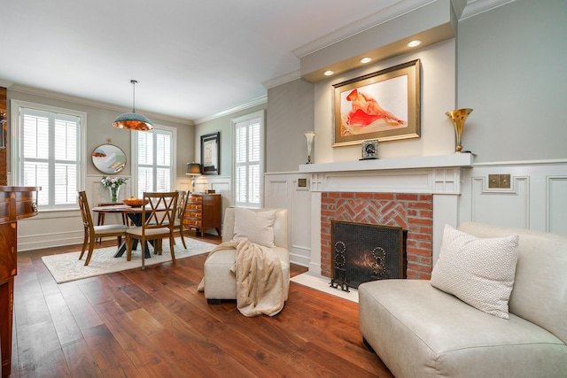 33 E Frankfort St, Columbus, OH 43206 - living area with crown molding, a decorative wall, dark wood-type flooring, a fireplace, and wainscoting