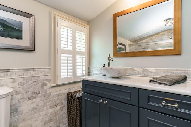 33 E Frankfort St, Columbus, OH 43206 - bathroom with tile walls, lofted ceiling, vanity, and wainscoting