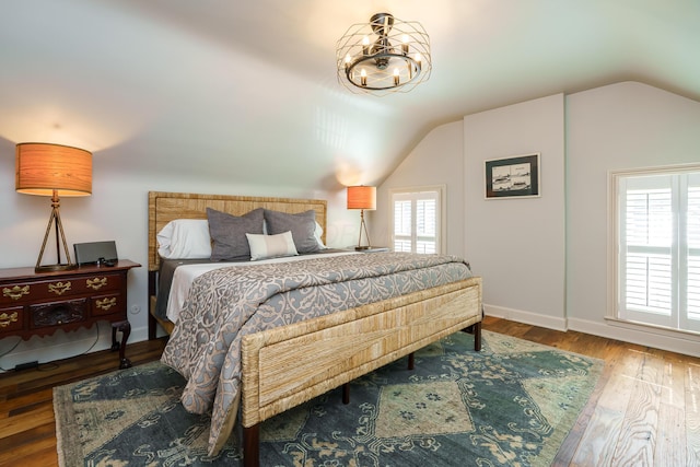 33 E Frankfort St, Columbus, OH 43206 - bedroom with vaulted ceiling, wood finished floors, and a chandelier