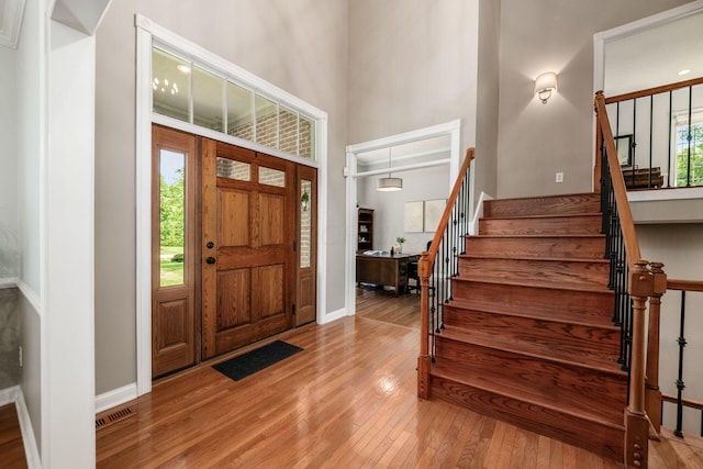 8918 Filiz Ln, Powell, OH 43065 - foyer featuring light wood-style flooring, stairs, and a high ceiling