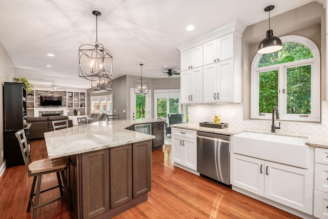 8918 Filiz Ln, Powell, OH 43065 - kitchen featuring dishwasher, open floor plan, white cabinets, decorative backsplash, and recessed lighting