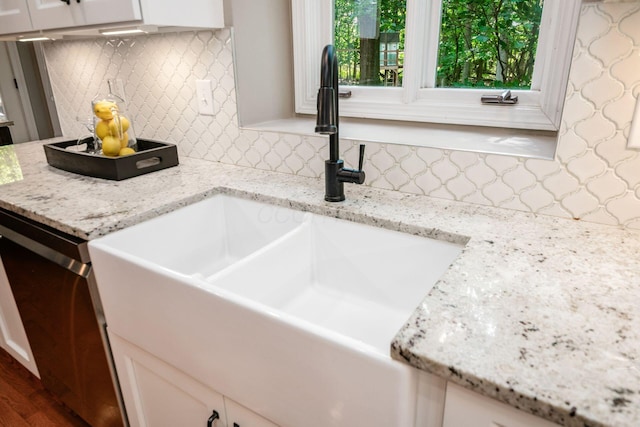 8918 Filiz Ln, Powell, OH 43065 - kitchen featuring decorative backsplash, white cabinetry, light stone countertops, and wood finished floors