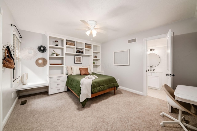 8918 Filiz Ln, Powell, OH 43065 - bedroom with light colored carpet, connected bathroom, ceiling fan, radiator heating unit, and a desk
