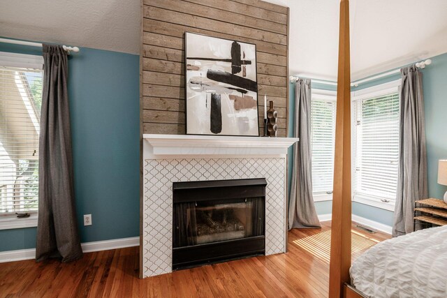 8918 Filiz Ln, Powell, OH 43065 - bedroom featuring wood finished floors and a tile fireplace