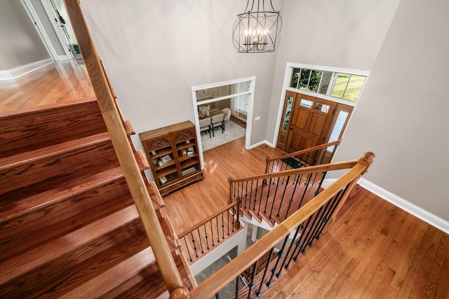 8918 Filiz Ln, Powell, OH 43065 - entrance foyer with a chandelier, wood finished floors, stairway, and a high ceiling