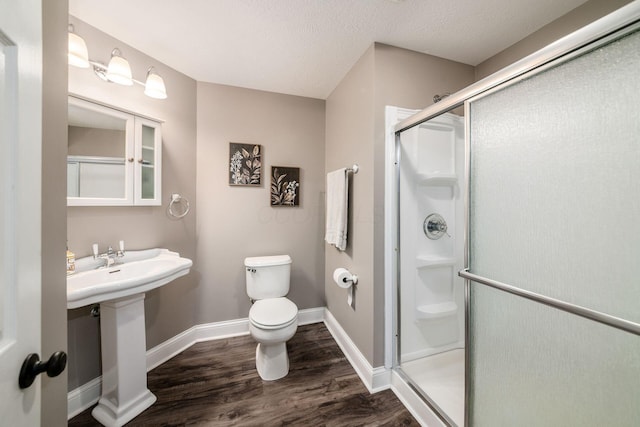 8918 Filiz Ln, Powell, OH 43065 - full bathroom with wood finished floors, a shower stall, and a textured ceiling