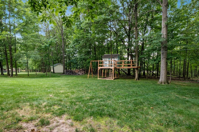 8918 Filiz Ln, Powell, OH 43065 - view of green lawn featuring a shed, a playground, and view of scattered trees
